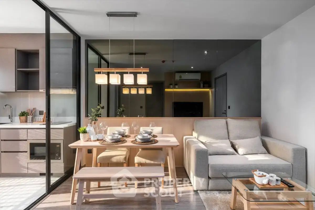 Modern open-plan living room with dining area and kitchen, featuring sleek design and natural light.