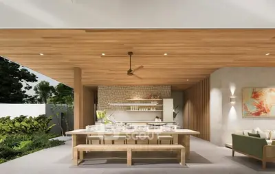 Luxurious open-plan kitchen with wooden ceiling and modern decor, perfect for entertaining.