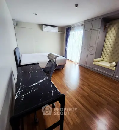 Spacious bedroom with elegant decor and natural light