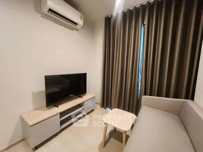 Modern living room with air conditioning, TV, and stylish furniture in a cozy apartment.