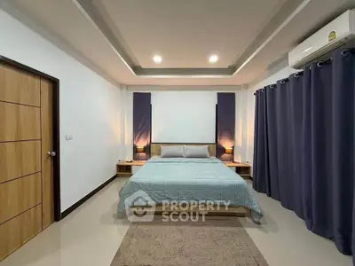 Spacious bedroom with modern decor and ambient lighting