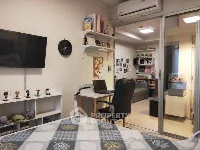 Modern bedroom with study area, featuring a wall-mounted TV, air conditioning, and stylish decor.