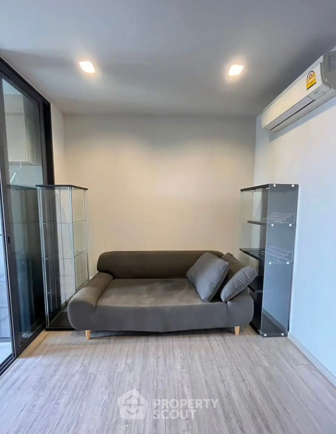 Modern living room with sleek sofa and glass display cabinets