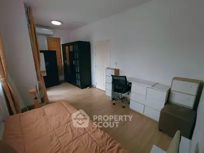 Spacious bedroom with modern furniture and ample storage space