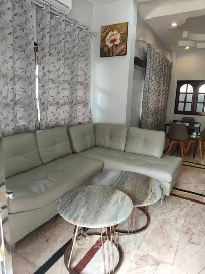 Stylish living room with modern sectional sofa and elegant marble coffee tables