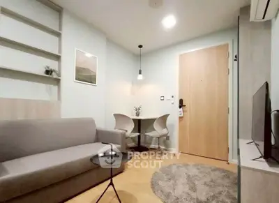 Modern living room with cozy seating and stylish decor in a contemporary apartment.
