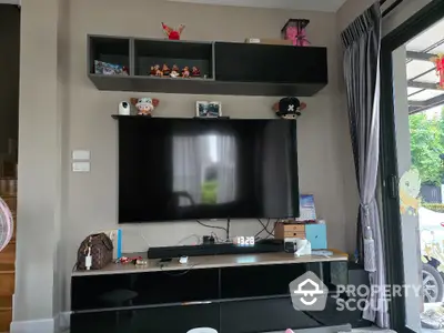 Modern living room with wall-mounted TV and stylish shelving