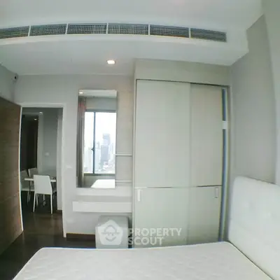 Modern bedroom with built-in wardrobe and city view