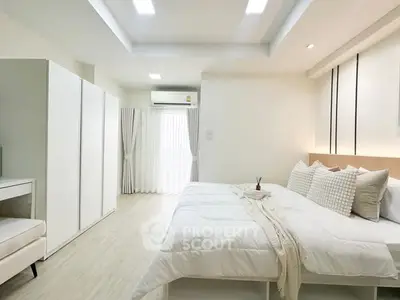 Spacious modern bedroom with elegant decor and natural light