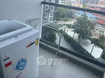 Modern balcony with washing machine and city view, perfect for urban living.