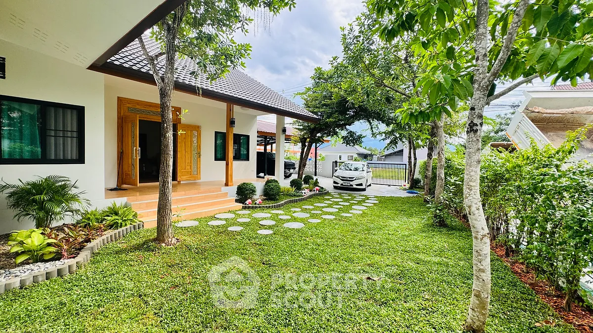 Charming single-story home with lush garden and carport in serene neighborhood.