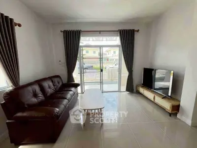 Spacious living room with modern sofa and TV, large window view