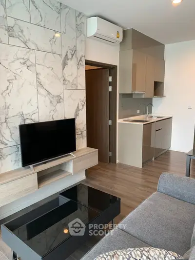 Modern living room with marble accent wall and sleek kitchen design