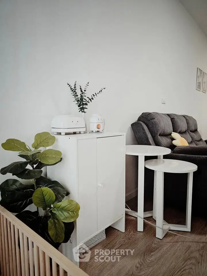 Modern living room with stylish furniture and indoor plants, creating a cozy and inviting atmosphere.