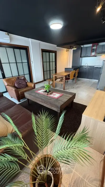 Modern living room with open kitchen and stylish decor