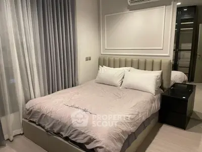 Modern bedroom with stylish decor and comfortable bedding in a cozy apartment.