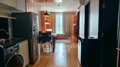 Modern open-layout kitchen and dining area with natural light and stylish decor