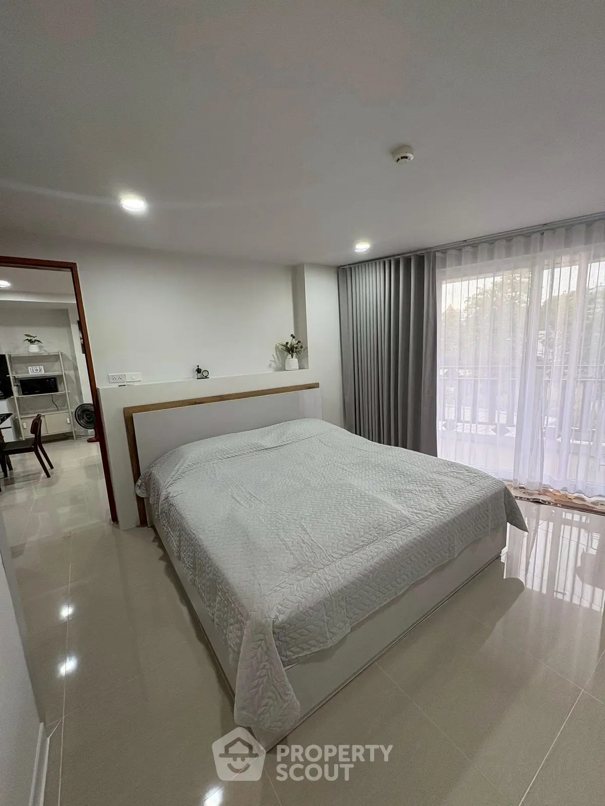 Modern bedroom with large window and elegant decor in a stylish apartment