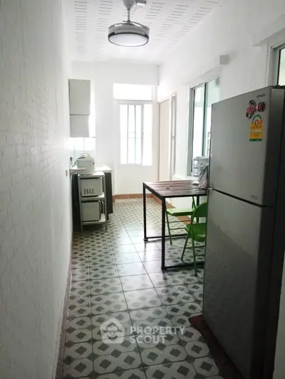 Charming kitchen with vintage tile flooring and modern appliances in a bright, airy space.