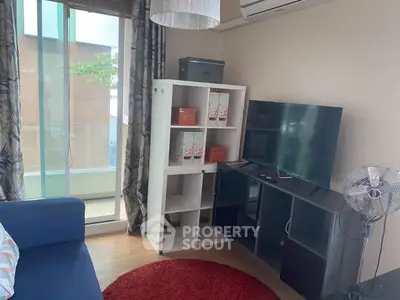 Cozy living room with modern decor and balcony access