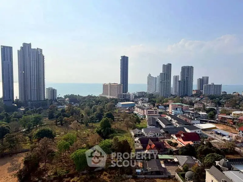 Stunning cityscape view with modern high-rise buildings and ocean backdrop, perfect for urban living enthusiasts.