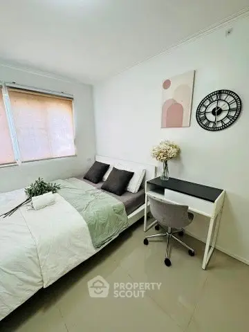 Cozy bedroom with modern decor, featuring a comfortable bed and stylish desk area.
