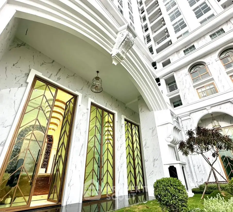 Elegant building exterior with marble facade and tall decorative windows