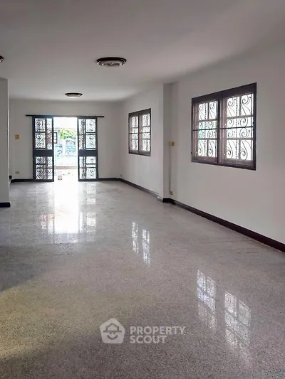 Spacious empty living room with large windows and natural light
