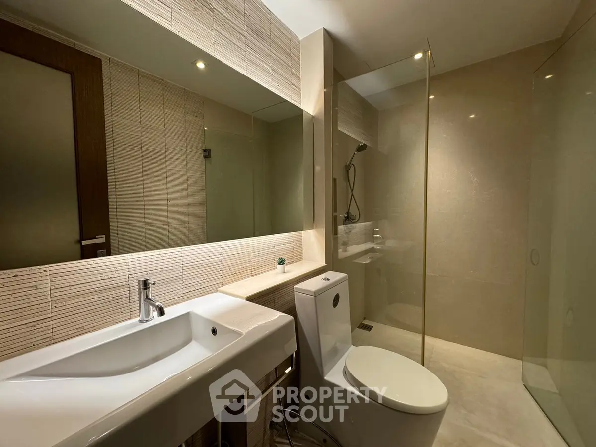 Modern bathroom with sleek fixtures and glass shower enclosure