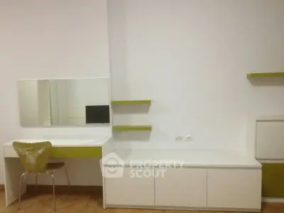Modern minimalist study room with sleek white furniture and green accents, perfect for productivity.