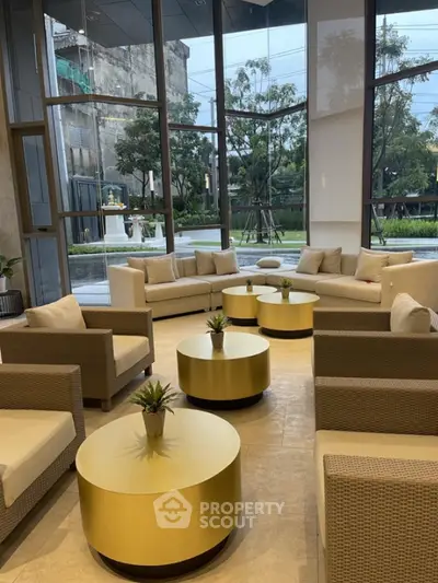 Luxurious modern living room with elegant furniture and large windows offering garden views.