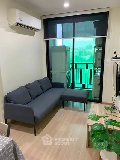 Modern living room with sleek sofa and balcony view in stylish apartment