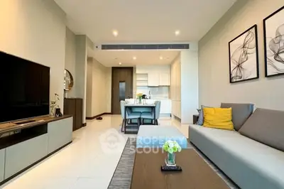 Modern open-layout living room with sleek kitchen and stylish decor