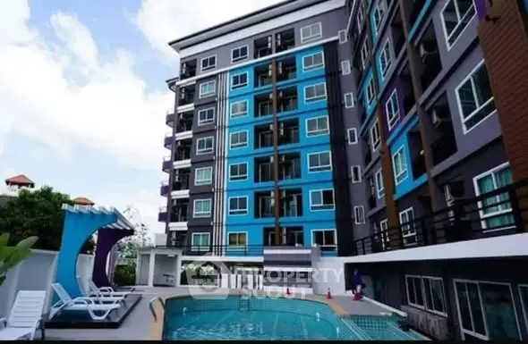 Modern apartment building with pool and lounge area, perfect for urban living.