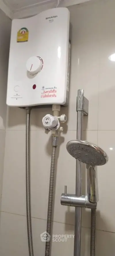 Modern bathroom with sleek shower and water heater installation.