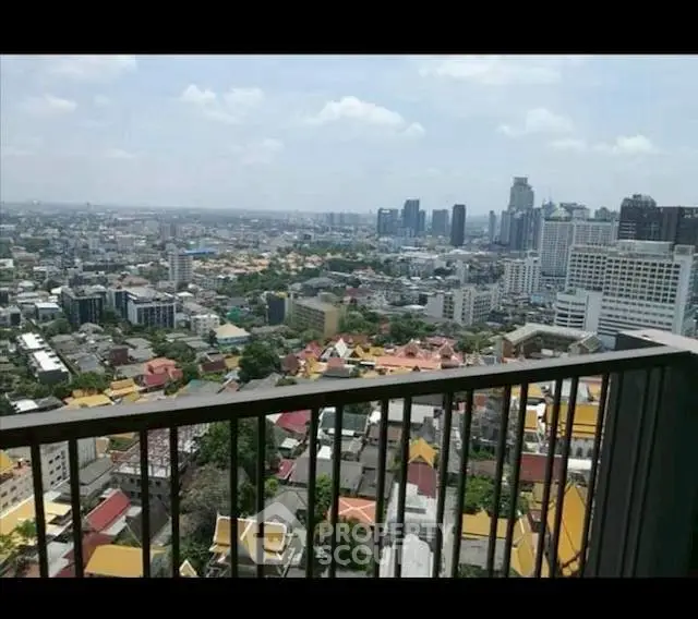 Stunning cityscape view from high-rise balcony overlooking urban skyline.