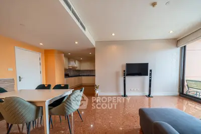 Spacious living room with modern decor and open kitchen layout