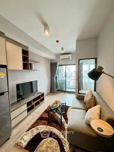 Modern living room with stylish decor and city view balcony.