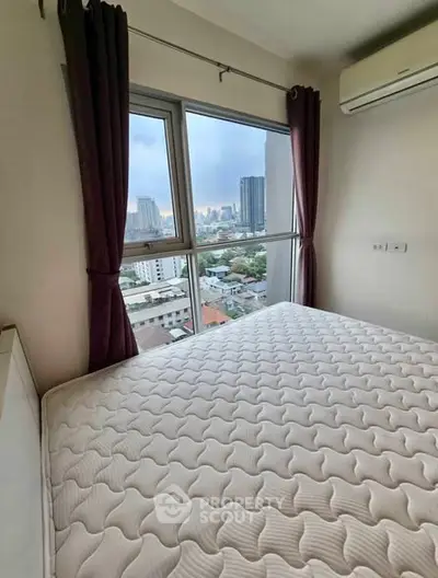 Cozy bedroom with city view and air conditioning in modern apartment