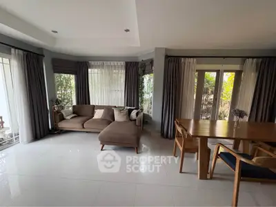 Spacious living room with modern furniture and large windows for natural light