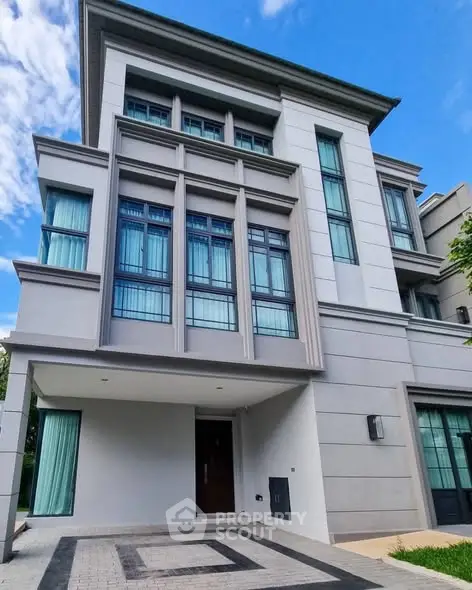 Modern multi-story building with large windows and sleek design