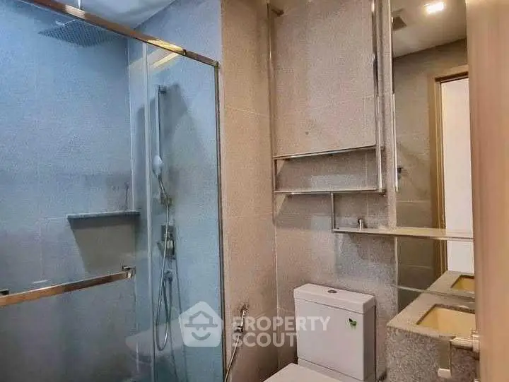 Modern bathroom with glass shower and sleek fixtures