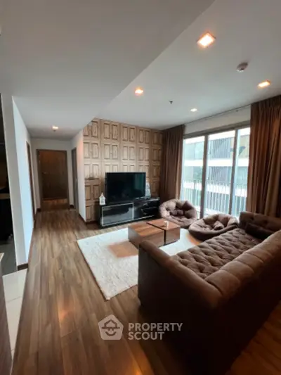 Spacious modern living room with stylish decor and large windows offering natural light.