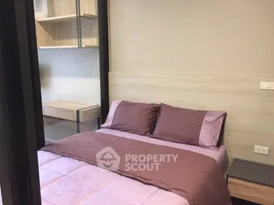 Cozy bedroom with modern wooden shelves and purple bedding in a stylish apartment.