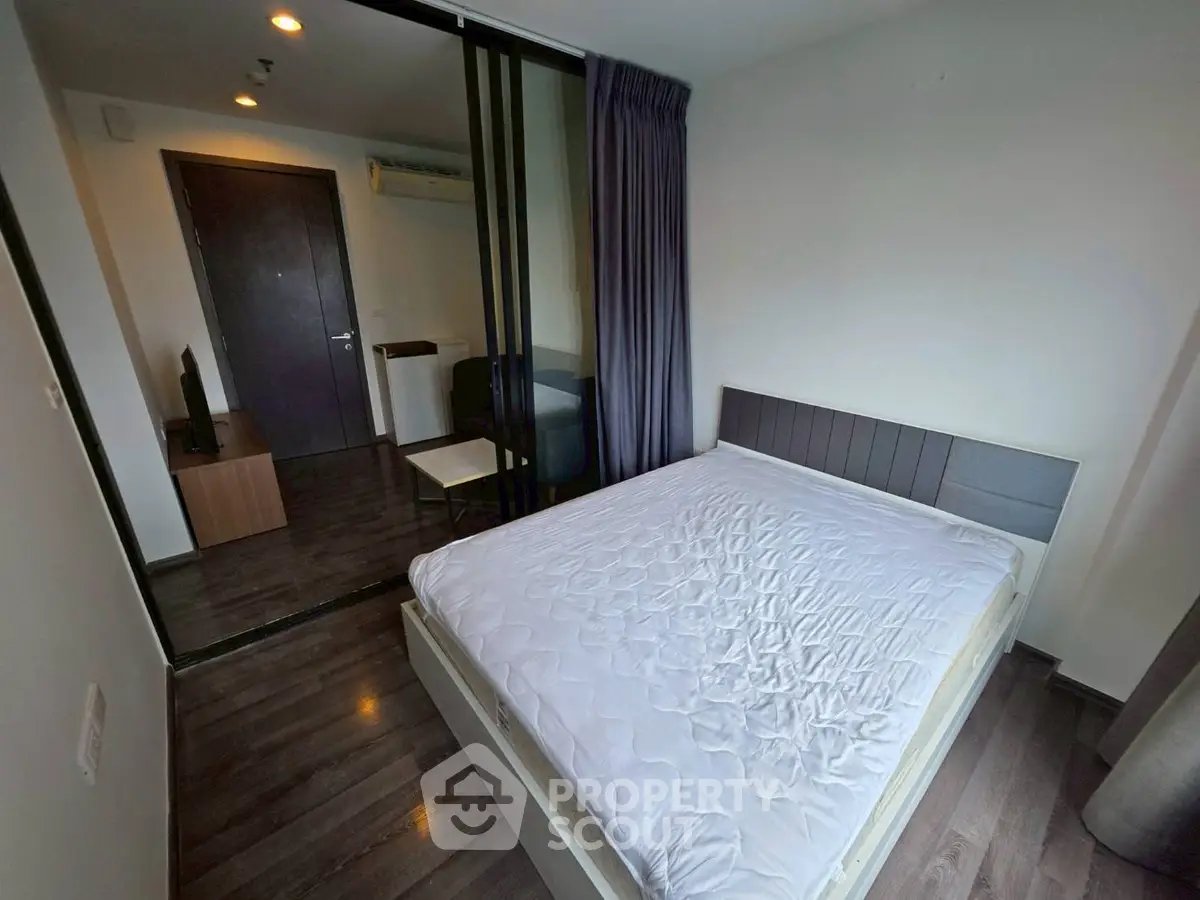 Modern bedroom with sleek design and glass partition in a stylish apartment.