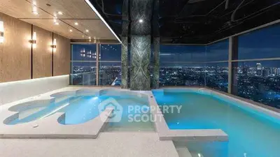 Luxurious indoor pool with stunning city skyline view at night