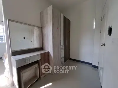 Modern bedroom with sleek wardrobe and vanity in bright natural light