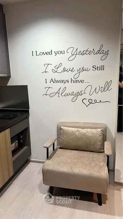 Cozy kitchen corner with stylish chair and romantic wall quote, perfect for intimate home settings.