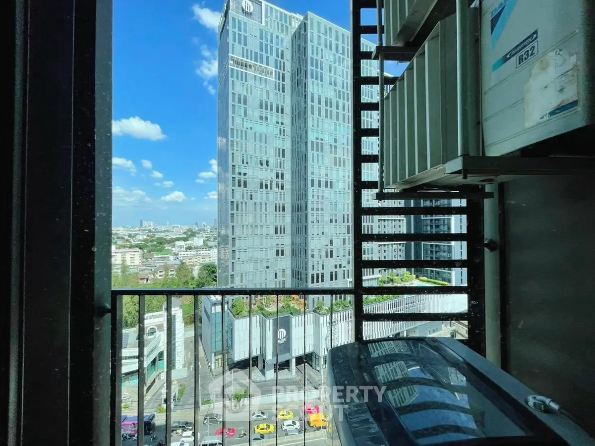 Stunning city view from a high-rise balcony with modern architecture and vibrant urban landscape.