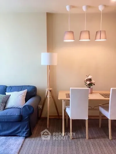 Cozy living room with stylish dining area and modern lighting